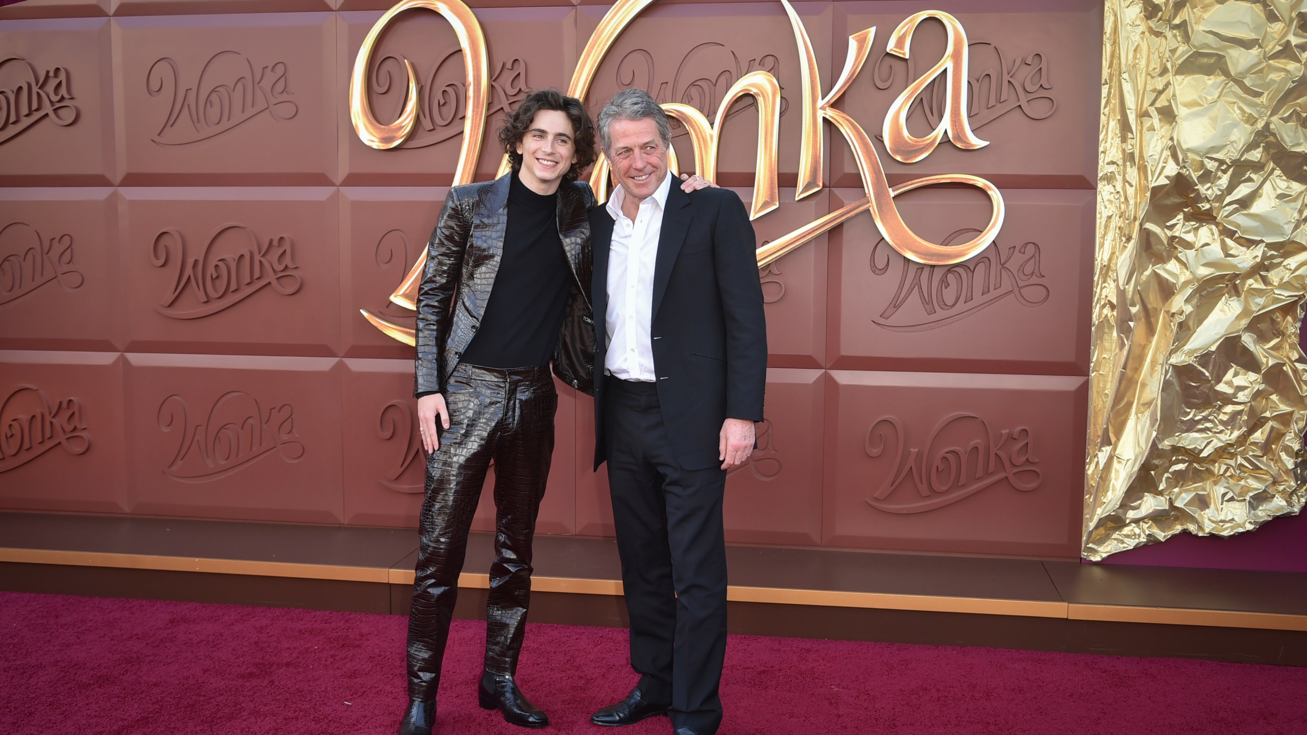 Timothee Chalamet, left, and Hugh Grant arrive at the premiere of "Wonka" on Sunday, Dec. 10, 2023, at Regency Village Theatre in Westwood, Calif. (Photo by Richard Shotwell/Invision/AP)