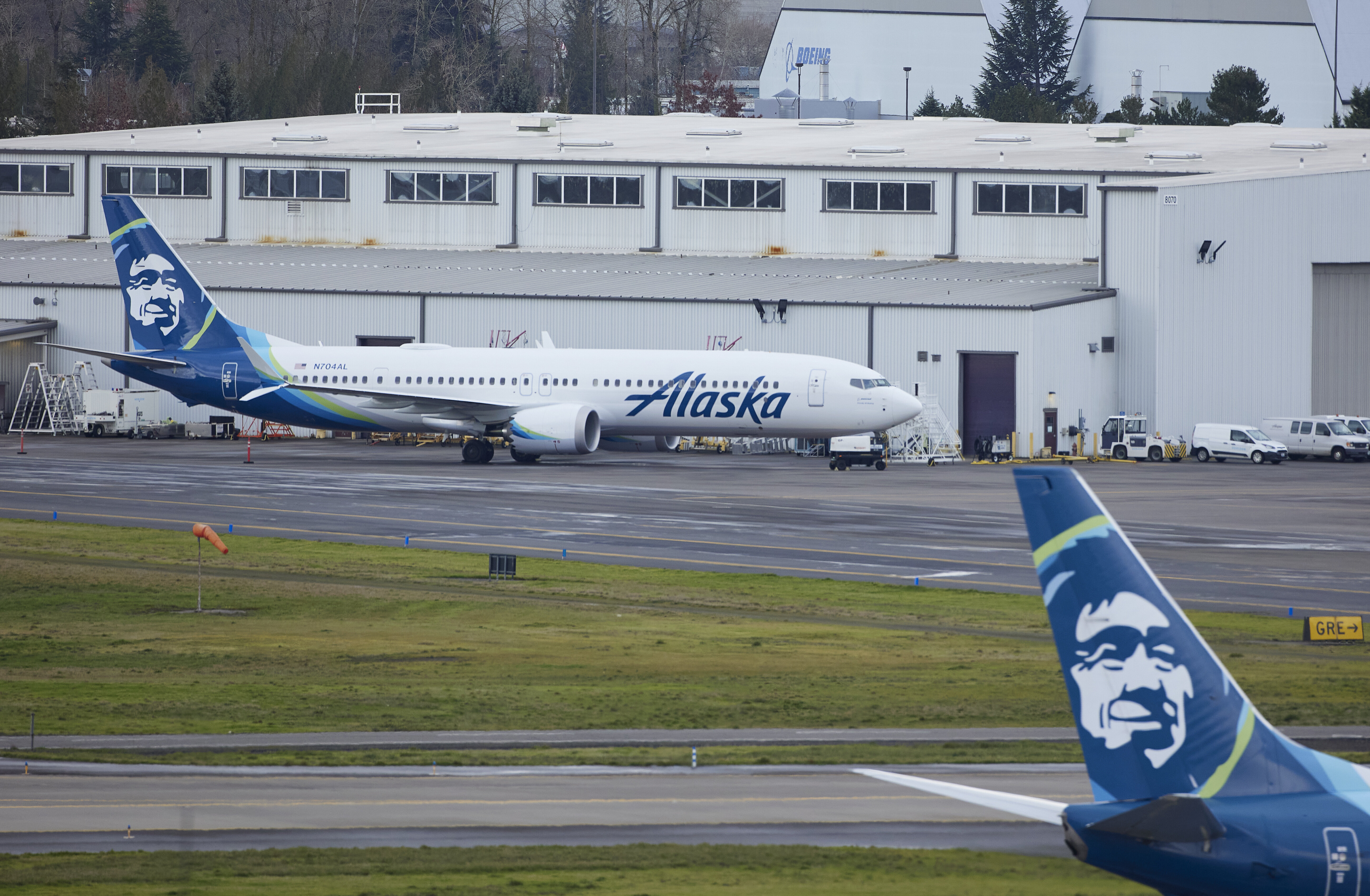 Alaska Airlines N704AL, a 737 Max 9 which made an emergency landing at Portland International Airport after a part of the fuselage broke off mid-flight on Friday, is parked at a maintenance hanger in Portland, Ore., Saturday, Jan. 6, 2024. (AP Photo/Craig Mitchelldyer)
